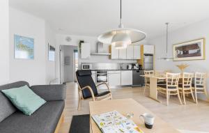 a living room with a couch and a table at Gudhjem Søpark Lejl 42 in Gudhjem