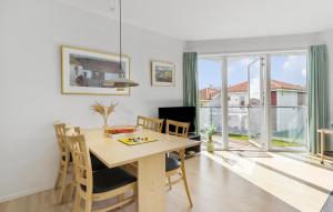 a dining room with a table and chairs and a window at Gudhjem Søpark Lejl 42 in Gudhjem