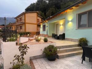 a house with a patio with stairs and chairs at RG MAISON - Suite 29 in Morino