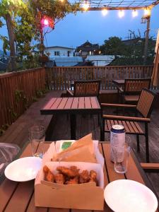 a box of food sitting on a table on a patio at Architect's Cat Hanok - Sindal House Gyeongju in Gyeongju