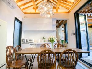 Un comedor con mesa y sillas de madera. en Hanok JADE, en Seúl