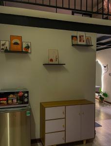 eine Küche mit Kühlschrank und Regalen an der Wand in der Unterkunft Zeus Living - Old Quater Homestay in Hanoi