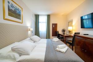 Postel nebo postele na pokoji v ubytování Hotel Volf