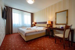 Postel nebo postele na pokoji v ubytování Hotel Volf
