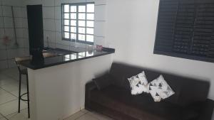 a living room with a couch and a mirror at Casa Limoeiro in Primavera do Leste +12 photos