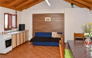 a kitchen and living room with a couch and a table at Pet Friendly Home In Nin With Kitchen in Nin