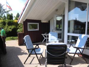 eine Gruppe von Stühlen auf einer Terrasse in der Unterkunft Ferienhaus Küstenschwalbe in Schönhagen