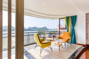 a living room with yellow chairs and a table at 桂林依庐居民宿 in Guilin