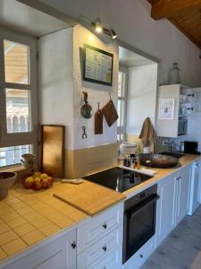 a kitchen with a counter top with fruits on it at Kalyvaki in Klíma +30 photos