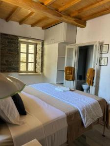 a bedroom with a large bed in a room at Kalyvaki in Klíma