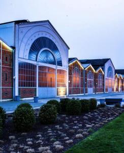 een groot gebouw met veel ramen en struiken bij Chic & Contemporain in Vierzon