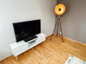 a flat screen tv sitting on a white entertainment center at Ferienwohnung Simmernblick in Simmern