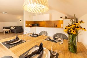 a dining room and kitchen with a table and chairs at Apartmaji Klavdija in Ljubljana