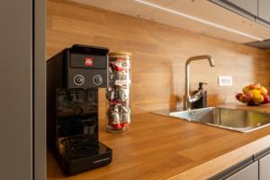 a kitchen with a coffee maker on a counter at Apartmaji Klavdija in Ljubljana
