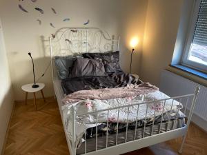 a bedroom with a white bed with a white frame at Janko's house in Maribor