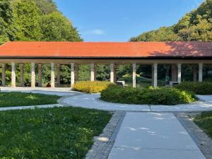 a pavilion with a walkway in a park at Janko's house in Maribor