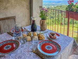 a table with plates of food and a vase on it at Chalet di montagna in pietra - Val di Chy in Val di Chy
