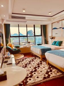 a hotel room with two beds and a large window at 桂林依庐居民宿 in Guilin
