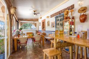 アロラにあるDos Alamos B&Bのバー、テーブル、椅子が備わるレストラン
