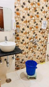 a bathroom with a sink and a shower curtain at Shri Ram Paying Guest House in Varanasi +48 photos