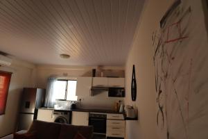 a kitchen with a drawing on the wall at Artsy B in Gaborone