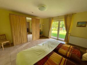 a bedroom with a large bed and a large window at Ostseehuus Apartment I in Steinbergkirche