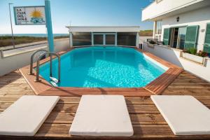 a swimming pool on the deck of a house at LA CASA DEL SOLE - Beachfront B&B - Anzio in Anzio
