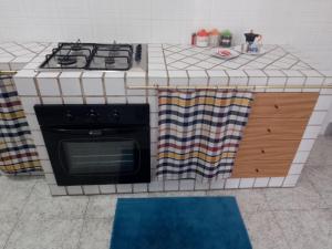 a kitchen with a stove and a counter top at Casa vacanze Emiliana in Ragusa +36 photos