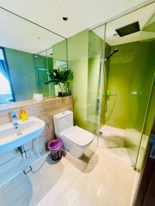 a bathroom with a toilet and a sink and a shower at Vortex suites klcc by Yashrib in Kuala Lumpur