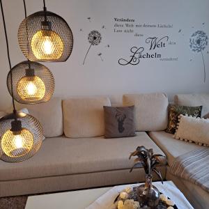 a living room with a couch and chandeliers at Ferienwohnung Inn-Blick in Passau