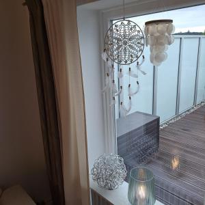 a room with a balcony with a fireplace and chandelier at Ferienwohnung Inn-Blick in Passau