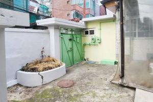 a garage with a green door and a building at 한옥스타일 Hongdae 7min #Sinchon 6min in Seoul