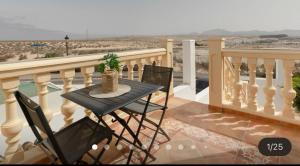 a table and chairs on a balcony with a view at Las Arenas Family in Costa Calma