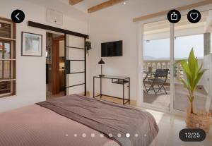 a bedroom with a bed and a balcony with a table at Las Arenas Family in Costa Calma