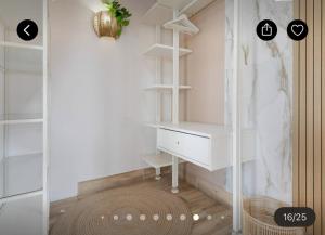 a dressing room with a white desk and shelves at Las Arenas Family in Costa Calma +16 photos