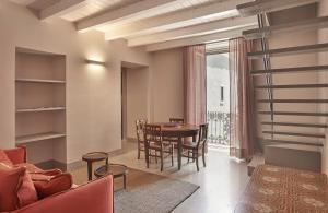 a living room with a table and chairs at Palazzo Scammacca in Catania