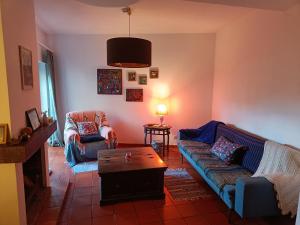 a living room with a couch and a coffee table at Casa Flow and Glow in Santiago do Cacém