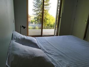 a bed in a room with a large window at Merveille du Mont in Météren