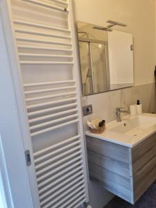 a bathroom with a sink and a mirror at Maso kreuzberg- Monolocale 3- vista montagne in Trento