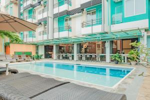 a swimming pool in front of a building at Sea Cocoon Hotel in El Nido