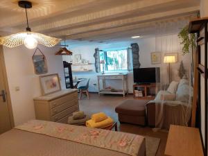 a living room with a bed and a couch at Purple Studio in Funchal