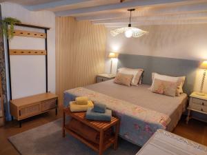 a bedroom with a large bed and a table at Purple Studio in Funchal +59 photos