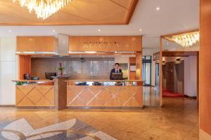 a man sitting at a desk in a hotel lobby at NH Ingolstadt in Ingolstadt +48 photos