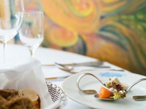 a plate of food on a table with a plate of food at Peters - das Genusshotel in der Wingst in Wingst +27 photos