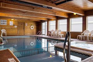 a large indoor pool with chairs in a building at MainStay Suites Fargo - I-94 Medical Center in Fargo