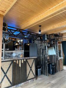 a room with a kitchen and a bar in a building at Panorama Gomismta in Gomi