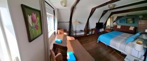 a bedroom with a bed and a table with a table at Het Burgemeestershuis in Barsingerhorn