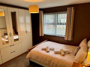 a bedroom with a bed with two towels on it at Marions Place in Finvoy