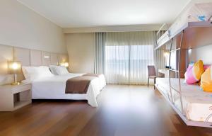 a hotel room with two beds and a large window at TRYP by Wyndham Porto Expo Hotel in Leça da Palmeira