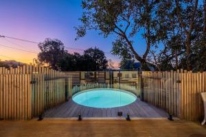 a fence around a swimming pool in a backyard at Jujube in Dromana